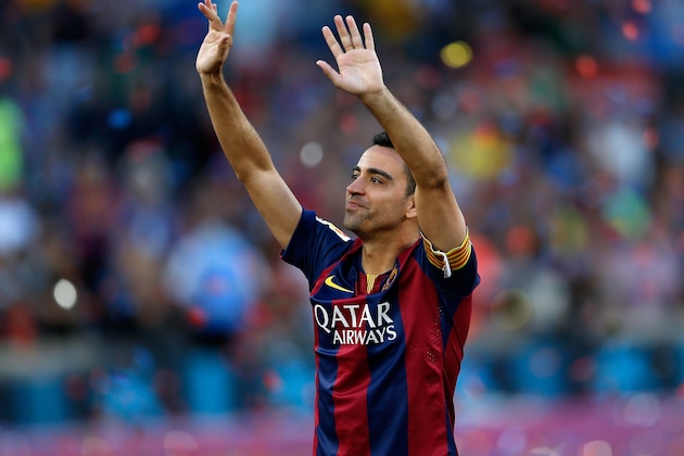 FC Barcelona's Xavi Hernandez waves to supporters after winning the Spanish League title, at the end of their Spanish La Liga last round soccer match against Deportivo Coruna at the Camp Nou stadium in Barcelona, Spain, Saturday, May 23, 2015. Hernandez says he will leave the Catalan club after 17 trophy-laden seasons in which he set club records for appearances and titles won. (AP Photo/Manu Fernandez)