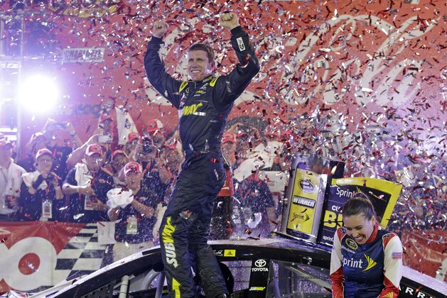 Carl Edwards celebrates in Victory Lane after winning the NASCAR Sprint Cup series auto race at Charlotte Motor Speedway in Concord, N.C., Sunday, May 24, 2015. (AP Photo/Chuck Burton)