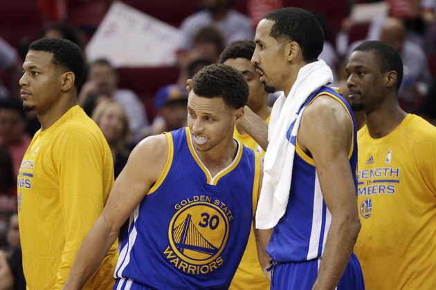 Golden State Warriors guard Stephen Curry (30) is greeted by guard Shaun Livingston (34) during the second half in Game 3 of the NBA basketball Western Conference finals Saturday, May 23, 2015, in Houston. The Warriors won 115-80. (AP Photo/David J. Phillip)