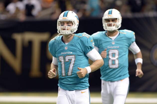 Miami Dolphins quarterback Ryan Tannehill (17) and quarterback Matt Moore (8) walk onto the field before an NFL football game against the New Orleans Saints in New Orleans, Monday, Sept. 30, 2013. (AP Photo/Bill Feig)