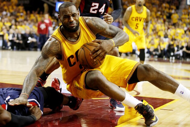 CLEVELAND, OH - MAY 24:  LeBron James #23 of the Cleveland Cavaliers knocks DeMarre Carroll #5 of the Atlanta Hawks to the court as he drives in the fourth quarter during Game Three of the Eastern Conference Finals of the 2015 NBA Playoffs at Quicken Loans Arena on May 24, 2015 in Cleveland, Ohio. NOTE TO USER: User expressly acknowledges and agrees that, by downloading and or using this Photograph, user is consenting to the terms and conditions of the Getty Images License Agreement.  (Photo by Gregory Shamus/Getty Images)