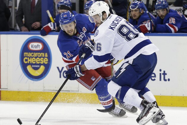 Tampa Bay Lightning right wing Nikita Kucherov (86) maintains control of the puck against New York Rangers center Derek Stepan (21) during the third period of Game 5 of the Eastern Conference final during the NHL hockey Stanley Cup playoffs, Sunday, May 24, 2015, in New York. (AP Photo/Frank Franklin)