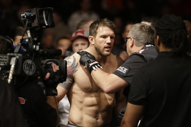 Ryan Bader checks before fighting with Vladimir Matyushenko during UFC Light Heavyweight Championship on FOX 6 at the United Center in Chicago, Saturday, Jan. 26, 2013. Bader won the bout. (AP Photo/Nam Y. Huh)