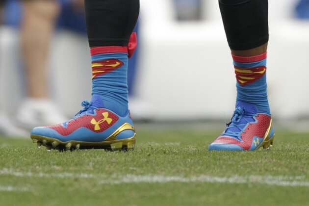 Carolina Panthers' Cam Newton wears shoes carrying the 'Superman' logo as he warms up before an NFL football game against the New Orleans Saints in Charlotte, N.C., Sunday, Dec. 22, 2013. (AP Photo/Bob Leverone)