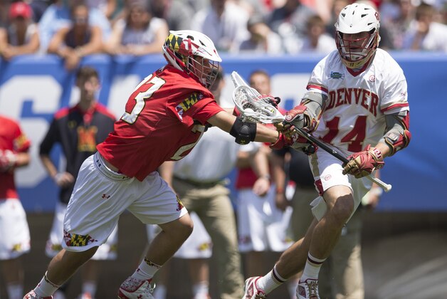 PHILADELPHIA, PA - MAY 25: Wesley Berg #14 of the Denver Pioneers controls the ball as Adam DiMillo #23 of the Maryland Terrapins checks him on May 25, 2015 in the NCAA Division I Men's Lacrosse Championship at Lincoln Financial Field in Philadelphia, Pennsylvania.  (Photo by Mitchell Leff/Getty Images)