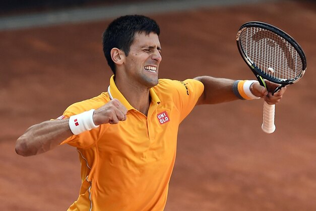 Serbia's Novak Djokovic celebrates after defeating Switzerland's Roger Federer in their men's final match at the Italian Open tennis tournament, in Rome, Sunday, May 17, 2015. Djokovic won 6-4 6-3. (Claudio Onorati/ANSA via AP) ITALY OUT