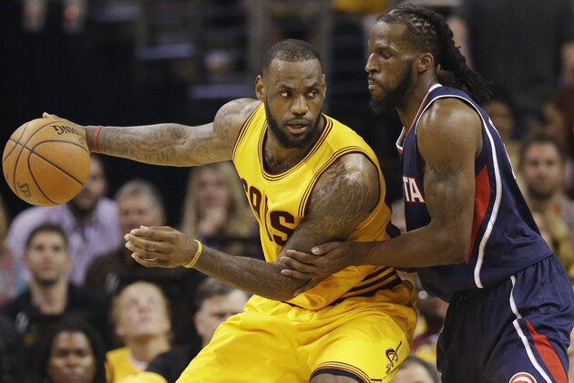 Cleveland Cavaliers' LeBron James, left, backs in on Atlanta Hawks' DeMarre Carroll during the first half in Game 3 of the Eastern Conference finals of the NBA basketball playoffs Sunday, May 24, 2015, in Cleveland. (AP Photo/Tony Dejak)