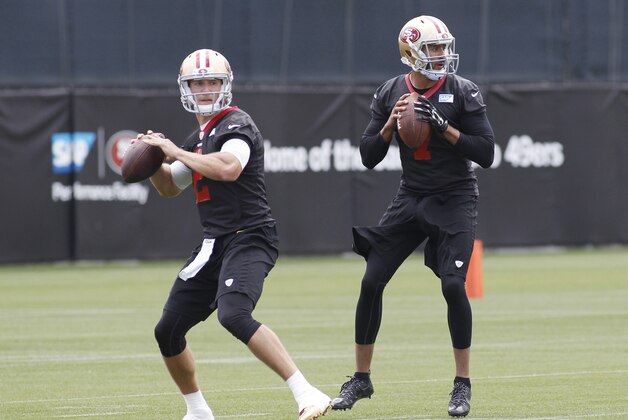 San Francisco 49ers quarterbacks Blaine Gabbert, left, and Colin Kaepernick look to pass during NFL football practice, Thursday, May 21, 2015, in Santa Clara, Calif. (AP Photo/George Nikitin)