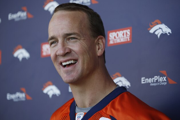 Denver Broncos quarterback Peyton Manning jokes with reporters after the NFL football team's voluntary veterans minicamp Tuesday, April 28, 2015, in Englewood, Colo. (AP Photo/David Zalubowski)
