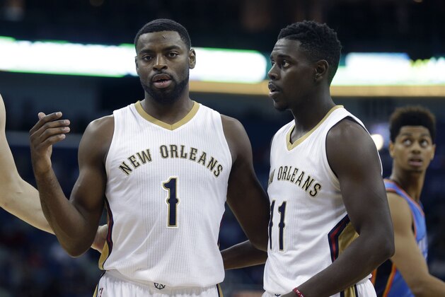 New Orleans Pelicans guard Tyreke Evans (1) calls together teammates forward Luke Babbitt (8) and guard Jrue Holiday (11) in the first half of an NBA preseason basketball game in New Orleans, Thursday, Oct. 16, 2014. (AP Photo/Gerald Herbert)