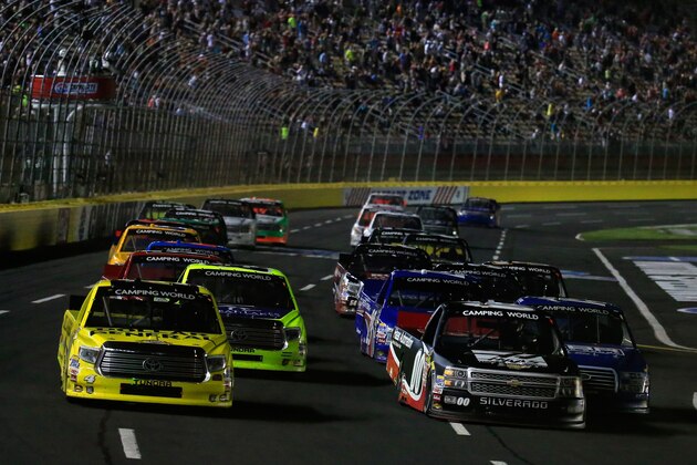 CHARLOTTE, NC - MAY 15:  Kasey Kahne, driver of the #00 Haas Automation Chevrolet, and Erik Jones, driver of the #4 Dollar General Toyota, lead the field in a restart during the NASCAR Camping World Truck Series North Carolina Education Lottery 200 at Charlotte Motor Speedway on May 15, 2015 in Charlotte, North Carolina.  (Photo by Chris Trotman/Getty Images)