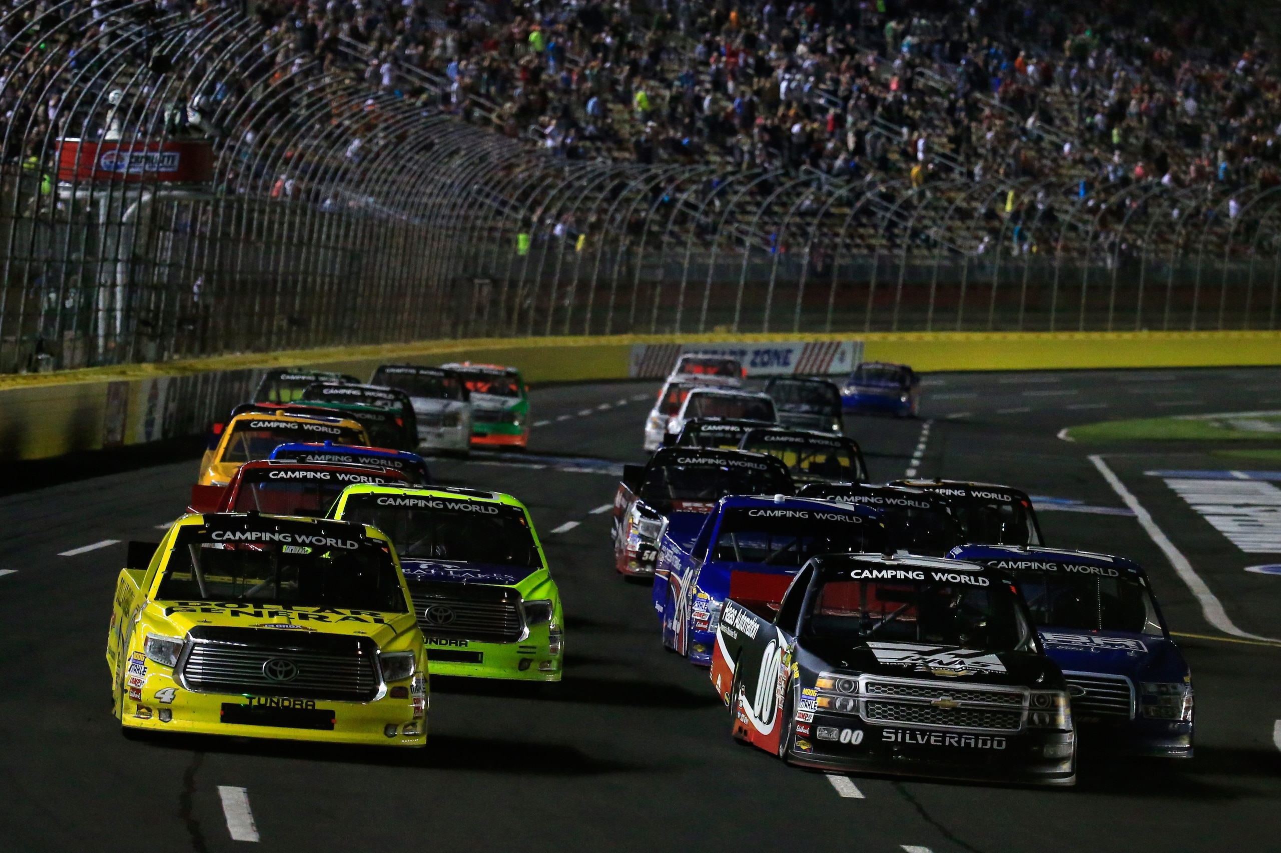 CHARLOTTE, NC - MAY 15:  Kasey Kahne, driver of the #00 Haas Automation Chevrolet, and Erik Jones, driver of the #4 Dollar General Toyota, lead the field in a restart during the NASCAR Camping World Truck Series North Carolina Education Lottery 200 at Charlotte Motor Speedway on May 15, 2015 in Charlotte, North Carolina.  (Photo by Chris Trotman/Getty Images)