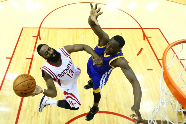 HOUSTON, TX - MAY 25:  James Harden #13 of the Houston Rockets goes up against Draymond Green #23 of the Golden State Warriors in the second half during Game Four of the Western Conference Finals of the 2015 NBA Playoffs at Toyota Center on May 25, 2015 in Houston, Texas.  NOTE TO USER: User expressly acknowledges and agrees that, by downloading and or using this photograph, user is consenting to the terms and conditions of Getty Images License Agreement.  (Photo by Ronald Martinez/Getty Images)