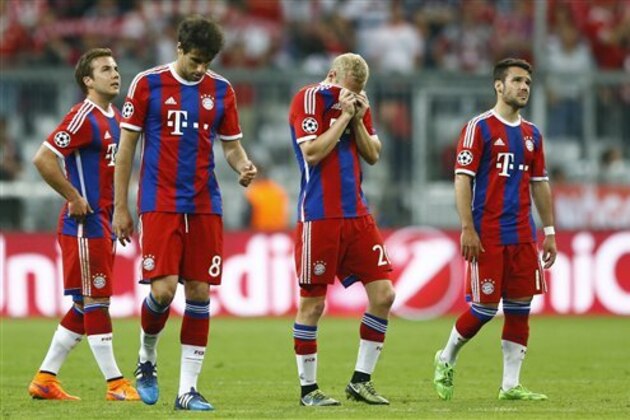 Bayern's Mario Goetze, Javi Martinez, Sebastian Rode and Juan Bernat, from left, react after failing to advance to the final after the soccer Champions League second leg semifinal match between Bayern Munich and FC Barcelona at Allianz Arena in Munich, southern Germany, Tuesday, May 12, 2015. (AP Photo/Matthias Schrader)