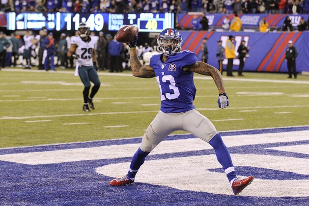 New York Giants' Odell Beckham (13) throws the football after scoring a touchdown during the second half of an NFL football game against the Philadelphia Eagles Sunday, Dec. 28, 2014, in East Rutherford, N.J. (AP Photo/Bill Kostroun)