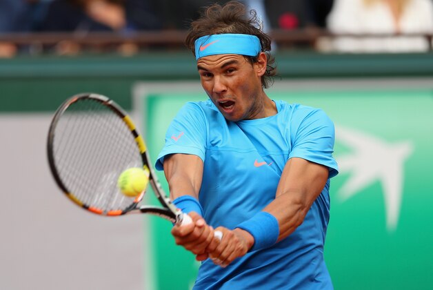 PARIS, FRANCE - MAY 26:  Rafael Nadal of Spain plays a backhand in his Men's Singles match against Quentin Halys of France on day three of the 2015 French Open at Roland Garros on May 26, 2015 in Paris, France.  (Photo by Clive Brunskill/Getty Images)
