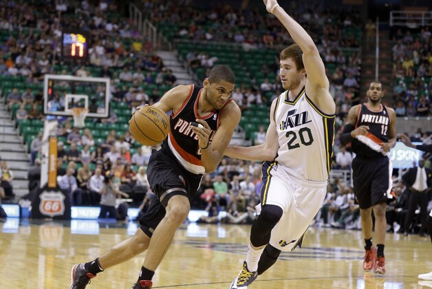 Portland Trail Blazers' Nicolas Batum (88) drives around Utah Jazz's Gordon Hayward (20) in the first quarter during an NBA basketball game Friday, April 11, 2014, in Salt Lake City. (AP Photo/Rick Bowmer)