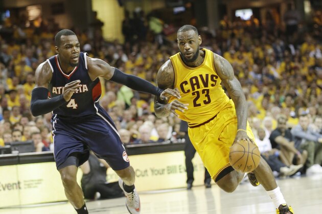 Cleveland Cavaliers' LeBron James (23) drives on Atlanta Hawks' Paul Millsap (4) during the second half in Game 3 of the Eastern Conference finals of the NBA basketball playoffs Sunday, May 24, 2015, in Cleveland. (AP Photo/Tony Dejak)