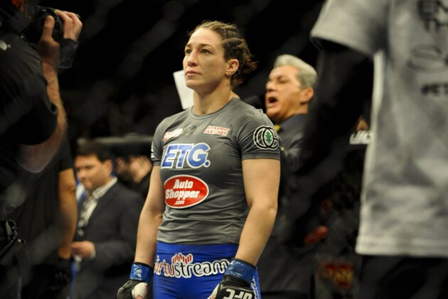 Feb 22, 2014; Las Vegas, NV, USA; Sara McMann (blue gloves) interviews after being defeated by Ronda Rousey (red gloves) during their UFC bantamweight championship bout at Mandalay Bay.  Mandatory Credit: Stephen R. Sylvanie-USA TODAY Sports
