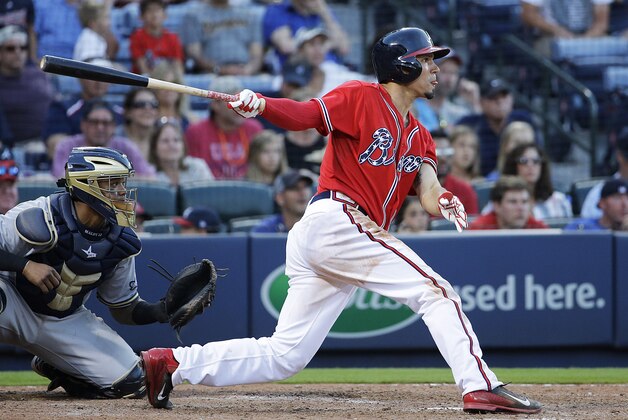 Atlanta Braves' Jace Peterson hits the game-winning single to score teammate Alberto Callaspo in the eleventh inning of a baseball game against the Milwaukee Brewers Saturday, May 23, 2015, in Atlanta. The Braves won 3-2. (AP Photo/David Goldman)