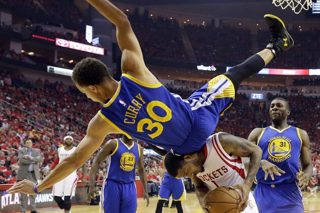 Golden State Warriors guard Stephen Curry (30) topples over Houston Rockets forward Trevor Ariza (1) during the first half in Game 4 of the Western Conference finals of the NBA basketball playoffs, Monday, May 25, 2015, in Houston. (AP Photo/David J. Phillip)