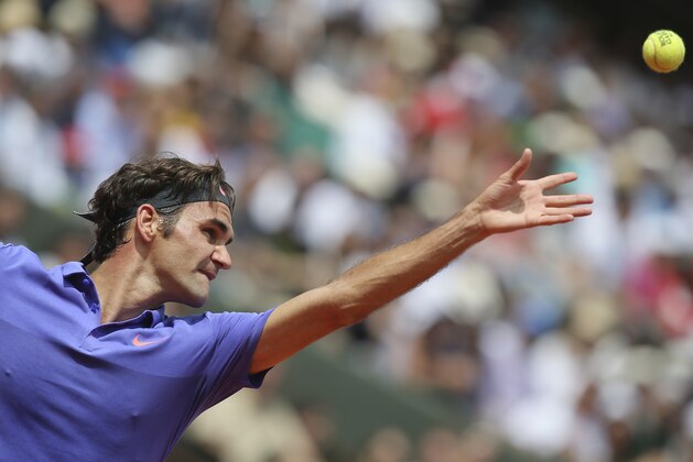 Switzerland's Roger Federer serves in the first round match of the French Open tennis tournament against Colombia's Alejandro Falla at the Roland Garros stadium, in Paris, France, Sunday, May 24, 2015. Federer won in three sets 6-3, 6-3. 6-4. (AP Photo/David Vincent)