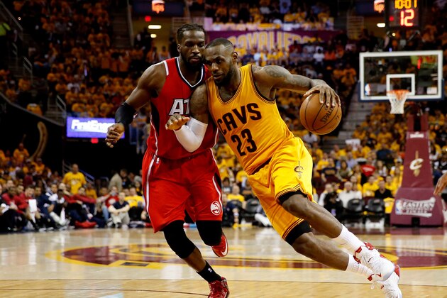 CLEVELAND, OH - MAY 26: LeBron James #23 of the Cleveland Cavaliers drives with the ball against DeMarre Carroll #5 of the Atlanta Hawks in the third quarter during Game Four of the Eastern Conference Finals of the 2015 NBA Playoffs at Quicken Loans Arena on May 26, 2015 in Cleveland, Ohio. NOTE TO USER: User expressly acknowledges and agrees that, by downloading and or using this Photograph, user is consenting to the terms and conditions of the Getty Images License Agreement.  (Photo by Gregory Shamus/Getty Images)