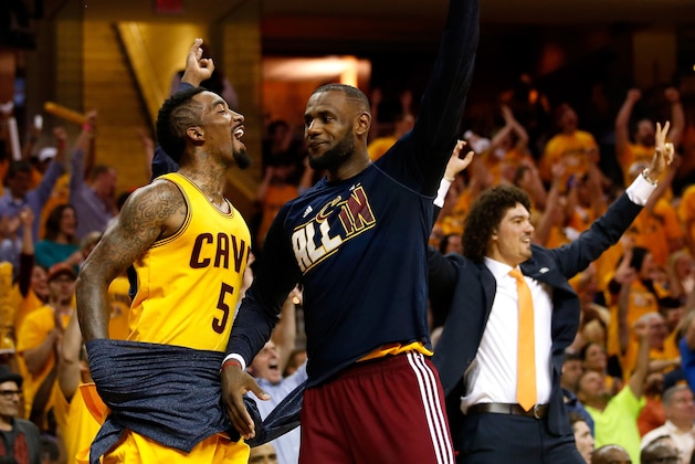 CLEVELAND, OH - MAY 26: J.R. Smith #5, LeBron James #23 and Anderson Varejao #17 of the Cleveland Cavaliers celebrate late in the fourth quarter against the Atlanta Hawks during Game Four of the Eastern Conference Finals of the 2015 NBA Playoffs at Quicken Loans Arena on May 26, 2015 in Cleveland, Ohio. NOTE TO USER: User expressly acknowledges and agrees that, by downloading and or using this Photograph, user is consenting to the terms and conditions of the Getty Images License Agreement.  (Photo by Gregory Shamus/Getty Images)