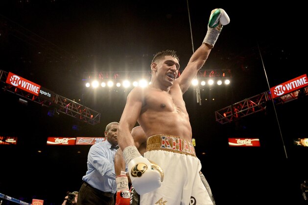 LAS VEGAS, NV-  DECEMBER 13:  Amir Khan (L) celebrates at the end of the 12th round against Devon Alexander during their welterweight bout at the MGM Grand Garden Arena on December 13, 2014 in Las Vegas, Nevada. Khan won with a 12-round unanimous decision. (Photo by Donald Miralle/Getty Images)
