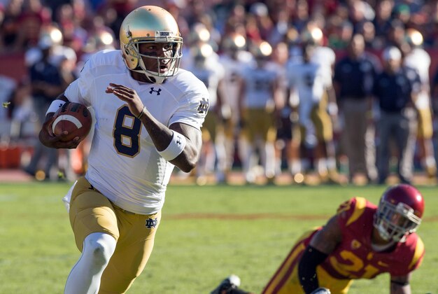Nov 29, 2014; Los Angeles, CA, USA; Notre Dame Fighting Irish quarterback Malik Zaire (8) runs for a touchdown in the second quarter against the USC Trojans at the Los Angeles Memorial Coliseum. Mandatory Credit: Matt Cashore-USA TODAY Sports