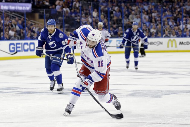 New York Rangers center Derick Brassard (16) shoots ahead of Tampa Bay Lightning defenseman Nikita Nesterov (89) in the third period of Game 6 of the Eastern Conference finals during an NHL hockey Stanley Cup playoffs game,Tuesday, May 26, 2015, in Tampa, Fla. (AP Photo/Chris O'Meara)