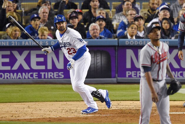 Los Angeles Dodgers' Adrian Gonzalez, left, watches his two-run home run off Atlanta Braves starting pitcher Julio Teheran, right, during the fifth inning of a baseball game, Tuesday, May 26, 2015, in Los Angeles. This was Gonzalez's 1000th career RBI. (AP Photo/Mark J. Terrill)