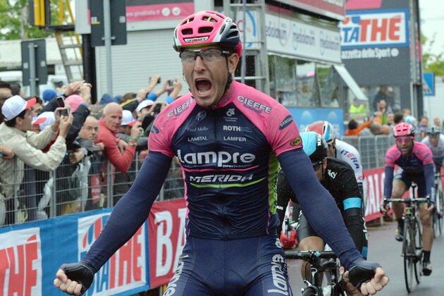 Italy's Sacha Modolo celebrates as he crosses the finish line to win the 13th stage of the Giro d'Italia, Tour of Italy cycling race from Montecchio Maggiore to the seaside resort of Jesolo, near Venice, Italy, Friday, May 22, 2015. Alberto Contador lost the overall lead of the Giro d'Italia to Fabio Aru after he was involved in a crash toward the end of Friday's 13th stage, which was won by Sacha Modolo. (Luca Zennaro/ANSA via AP)