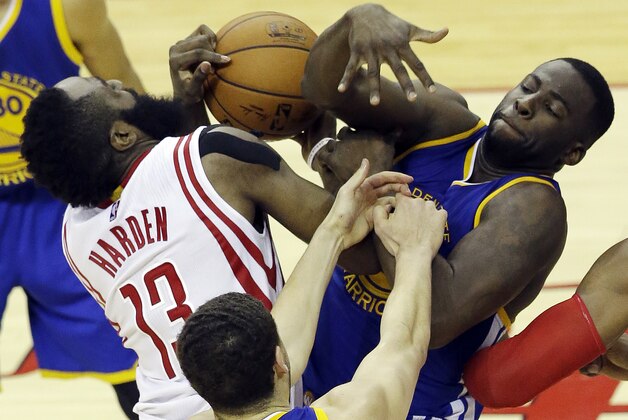 Houston Rockets guard James Harden (13) and Golden State Warriors forward Draymond Green (23) grapple for the ball as guard Klay Thompson (11) reaches in during the second half in Game 4 of the NBA basketball Western Conference finals Monday, May 25, 2015, in Houston. (AP Photo/Pat Sullivan)