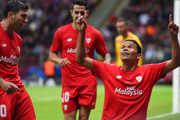WARSAW, POLAND - MAY 27:  Carlos Bacca of Sevilla celebrates scoring his team's second goal with Jose Antonio Reyes (L) of Sevilla during the UEFA Europa League Final match between FC Dnipro Dnipropetrovsk and FC Sevilla on May 27, 2015 in Warsaw, Poland.  (Photo by Shaun Botterill/Getty Images)