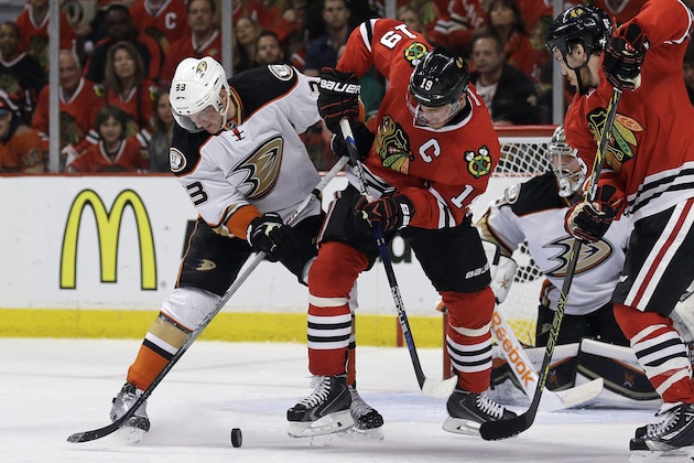 Anaheim Ducks right wing Jakob Silfverberg (33) and Chicago Blackhawks center Jonathan Toews (19) work for the puck during the second period in Game 4 of the Western Conference finals of the NHL hockey Stanley Cup playoffs, Saturday, May 23, 2015, in Chicago. (AP Photo/Nam Y. Huh)