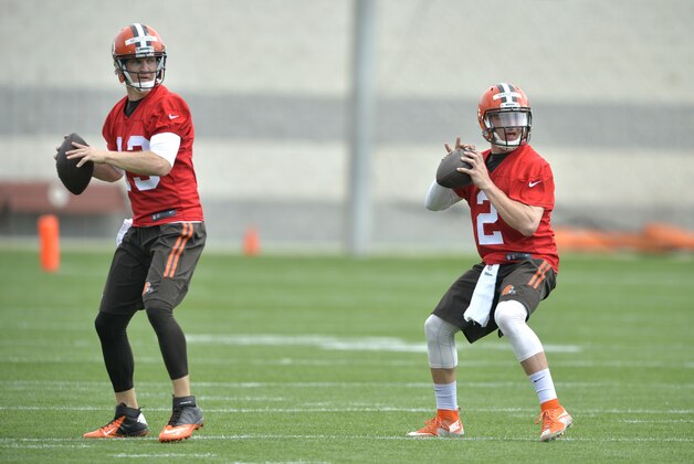 Cleveland Browns quarterback Johnny Manziel (2) practices beside quarterback Josh McCown (13) during an NFL organized training activity in Berea, Ohio, Tuesday, May 26, 2015. (AP Photo/David Richard)