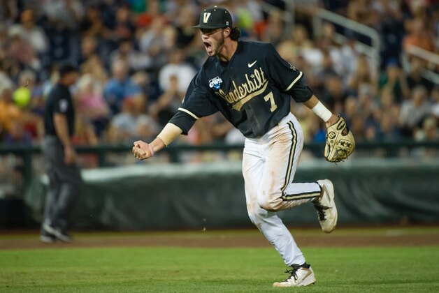 Jun 25, 2014; Omaha, NE, USA; Vanderbilt Commodores infielder Dansby Swanson (7) celebrates an inning ending play in the eighth inning against the Virginia Cavaliers during game three of the College World Series Finals at TD Ameritrade Park Omaha. Vanderbilt defeated Virginia 3-2 to win the College World Series. Mandatory Credit: Steven Branscombe-USA TODAY Sports