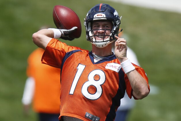 Denver Broncos quarterback Peyton Manning throws a pass during drills at an NFL football organized team activity Wednesday, May 27, 2015, in Englewood, Colo. (AP Photo/David Zalubowski)