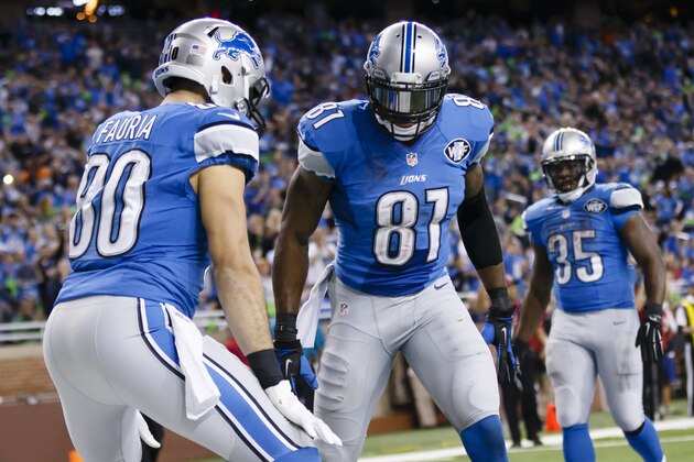 Detroit Lions tight end Joseph Fauria (80) receives congratulations from wide receiver Calvin Johnson (81) and running back Joique Bell (35) after scoring a touchdown against the Tampa Bay Buccaneers during an NFL football game at Ford Field in Detroit, Sunday, Dec. 7, 2014. (AP Photo/Rick Osentoski)