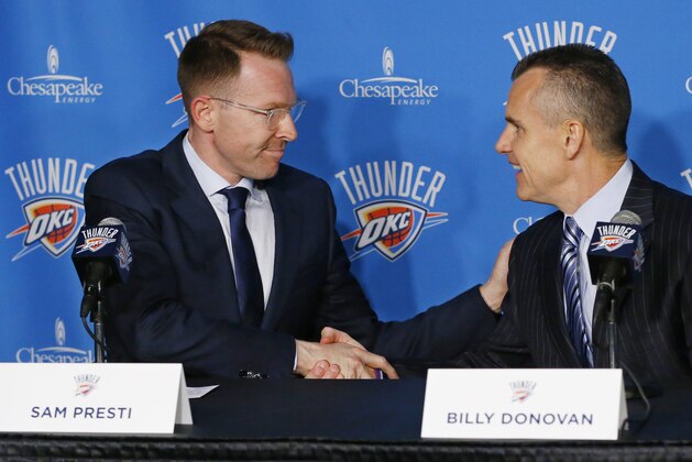 Billy Donovan, right, newly named head coach of the NBA basketball Oklahoma City Thunder, shakes hands with Sam Presti, left, Thunder general manager, as he is introduced at a news conference in Oklahoma City, Friday, May 1, 2015. (AP Photo/Sue Ogrocki)