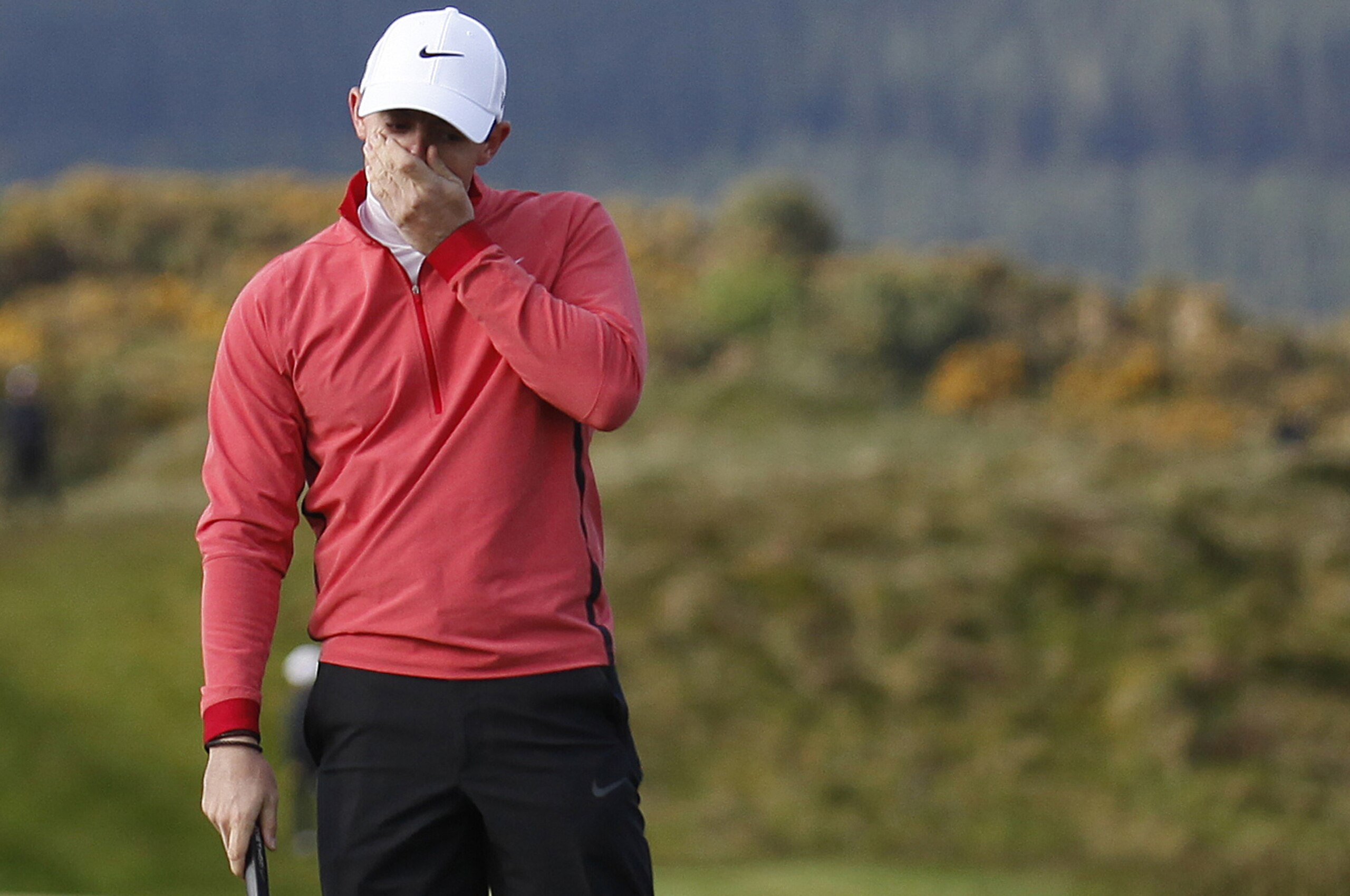 Northern Ireland's Rory McIlroy reacts after missing a putt on hole 11 during round one of the Irish Open Golf Championship at Royal County Down, Newcastle, Northern Ireland, Thursday, May 28, 2015.  (AP Photo/Peter Morrison)