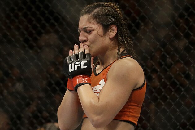 Bethe Correia celebrates after defeating Shayna Baszler in a women's bantamweight mixed martial arts bout at UFC 177 in Sacramento, Calif., Saturday, Aug. 30, 2014. Correia won in the second round. (AP Photo/Jeff Chiu)