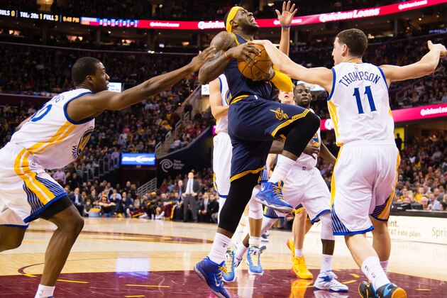 zCLEVELAND, OH - FEBRUARY 26: Harrison Barnes #40 and Klay Thompson #11 of the Golden State Warriors try to stop LeBron James #23 of the Cleveland Cavaliers during the second half at Quicken Loans Arena on February 26, 2015 in Cleveland, Ohio. The Cavaliers defeated the Warriors 110-99. NOTE TO USER: User expressly acknowledges and agrees that, by downloading and or using this photograph, User is consenting to the terms and conditions of the Getty Images License Agreement. (Photo by Jason Miller/Getty Images)