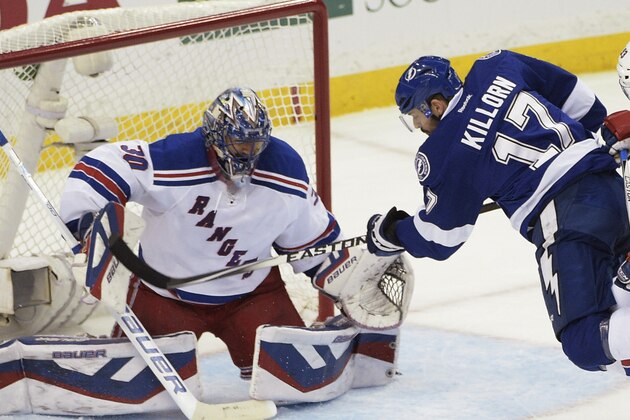 Tampa Bay Lightning center Alex Killorn (17) gets tangled up with New York Rangers defenseman Keith Yandle (93) while Rangers goalie Henrik Lundqvist (30), of Sweden, watches the puck during the first period of Game 6 of the Eastern Conference finals in the NHL hockey Stanley Cup playoffs, Tuesday, May 26, 2015, in Tampa, Fla. (AP Photo/Phelan M. Ebenhack)