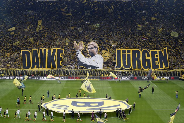 Dortmund supporters show banners to thank Dortmund's head coach Juergen Klopp prior to the German first division Bundesliga soccer match between BvB Borussia Dortmund  and Werder Bremen in Dortmund, Germany, Saturday, May 23, 2015. Klopp leaves the team after this season.(AP Photo/Frank Augstein)
