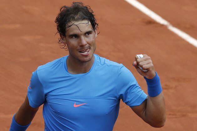 Spain's Rafael Nadal clenches his fist after defeating compatriot Nicolas Almagro during their second round match of the French Open tennis tournament at the Roland Garros stadium, Thursday, May 28, 2015 in Paris,  (AP Photo/Christophe Ena)