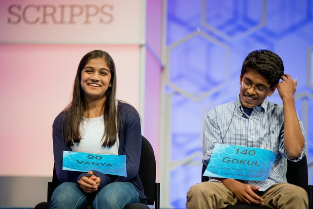 The remaining two spellers Vanya Shivashankar, 13, left, of Olathe, Kan., and Gokul Venkatachalam, 14, right, of St. Louis, sit on stage during the finals of the Scripps National Spelling Bee, Thursday, May 28, 2015, in Oxon Hill, Md. (AP Photo/Andrew Harnik)