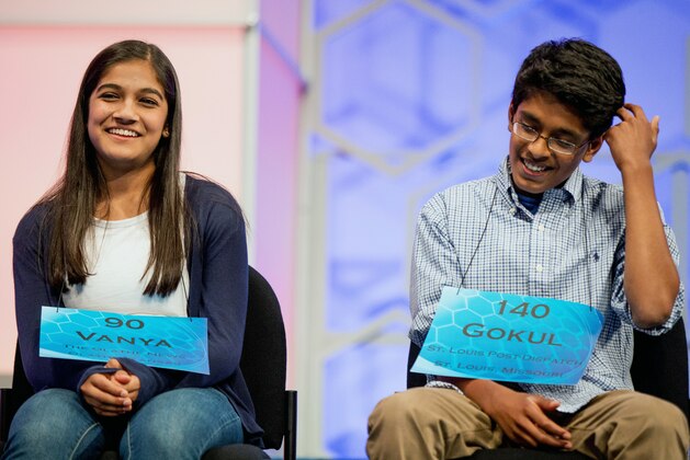 The remaining two spellers Vanya Shivashankar, left, 13, of Olathe, Kan., and Gokul Venkatachalam, 14, of St. Louis, sit onstage during the finals of the Scripps National Spelling Bee, Thursday, May 28, 2015, in Oxon Hill, Md. (AP Photo/Andrew Harnik)