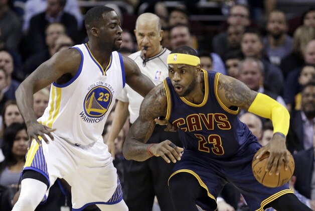 Cleveland Cavaliers' LeBron James, right, drives past Golden State Warriors’ Draymond Green during the first quarter of an NBA basketball game Thursday, Feb. 26, 2015, in Cleveland. (AP Photo/Tony Dejak)